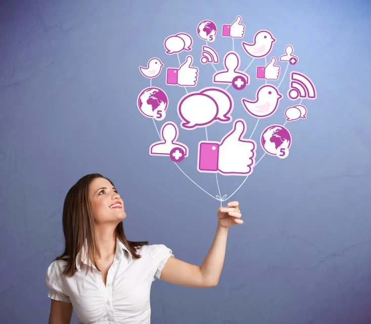 Woman holding social media icon balloons.